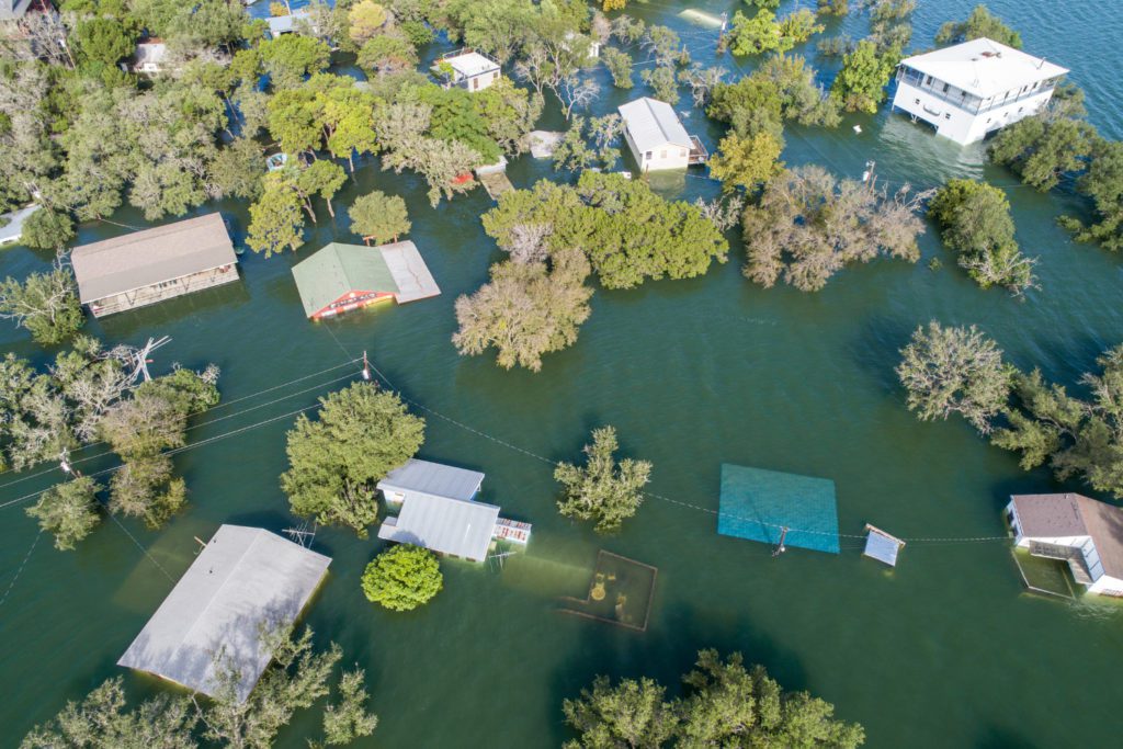 major flooding with houses submerged in water - importance of flood insurance